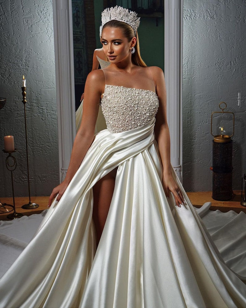 Elegant beaded satin wedding dress. Satin wedding dress with split thigh with sparkling beads